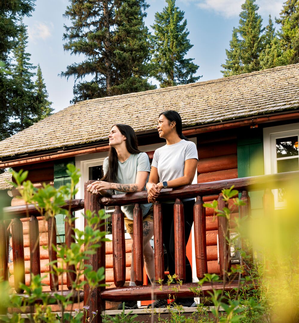A couple enjoying a stay at a quaint mountain cabin in Banff National Park.